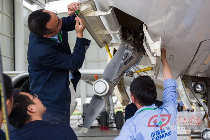 April 20, 2017: COMAC engineers make adjustments to the C919 before a high-speed taxiing test in Shanghai. by Wan Quan/China Pictorial