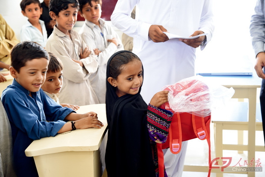 August 31, 2016: Students receive schoolbags and stationery donated by the CFPD at the China-Pakistan Government Primary School in Faqeer Colony, Gwadar.
