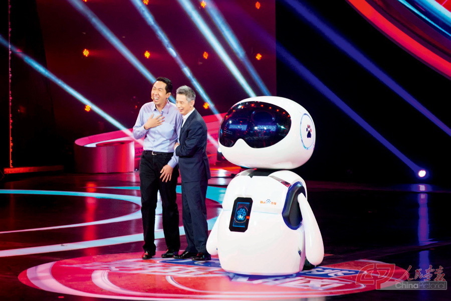 January 7, 2017: Andrew Ng (left) takes a Baidu-developed AI robot to participate in the popular television show Super Brain in China, for a battle between AI robots and human competitors. IC